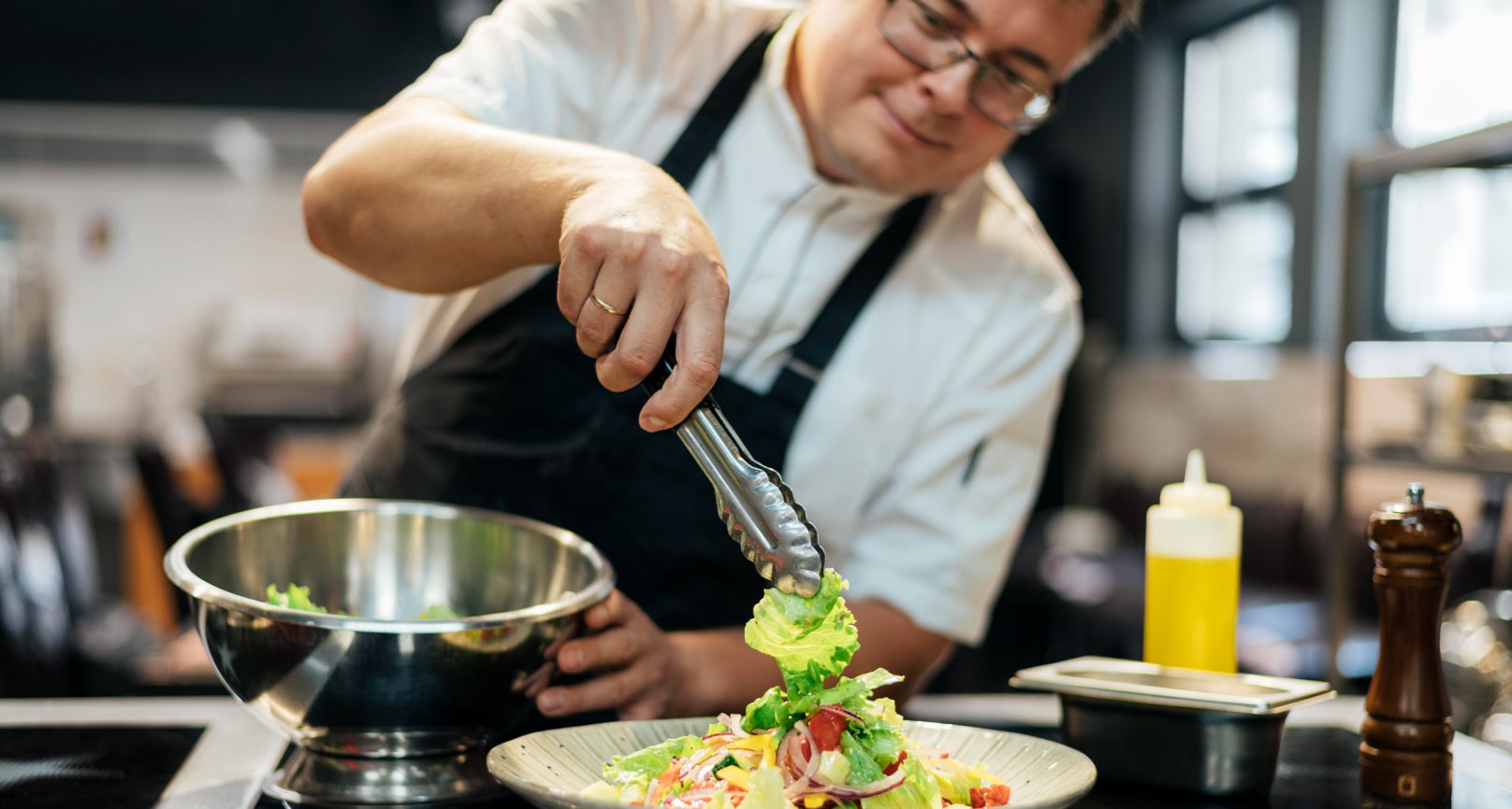 Chef prepares a salad dish