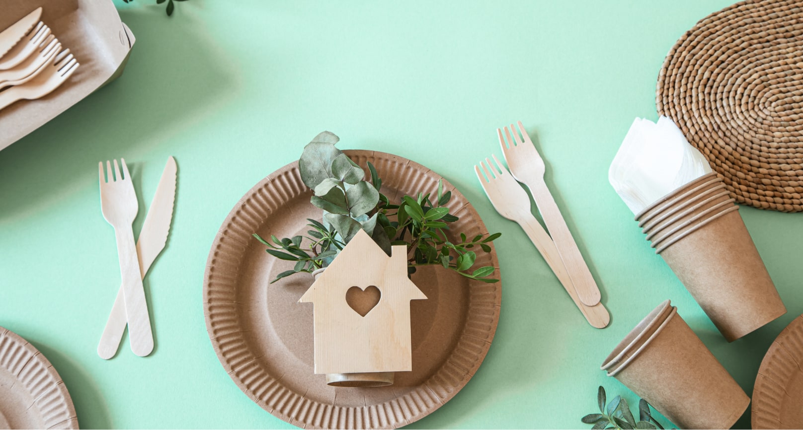 Sustainable plates with a green plant and a house cut-out